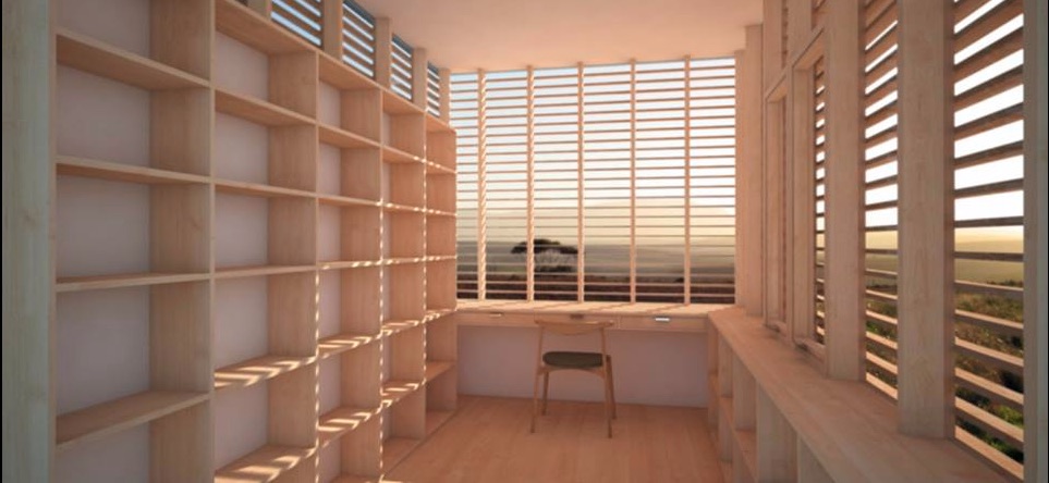Inside of the library provided by Camera Buildings, showing shelves, windows, and desk space.