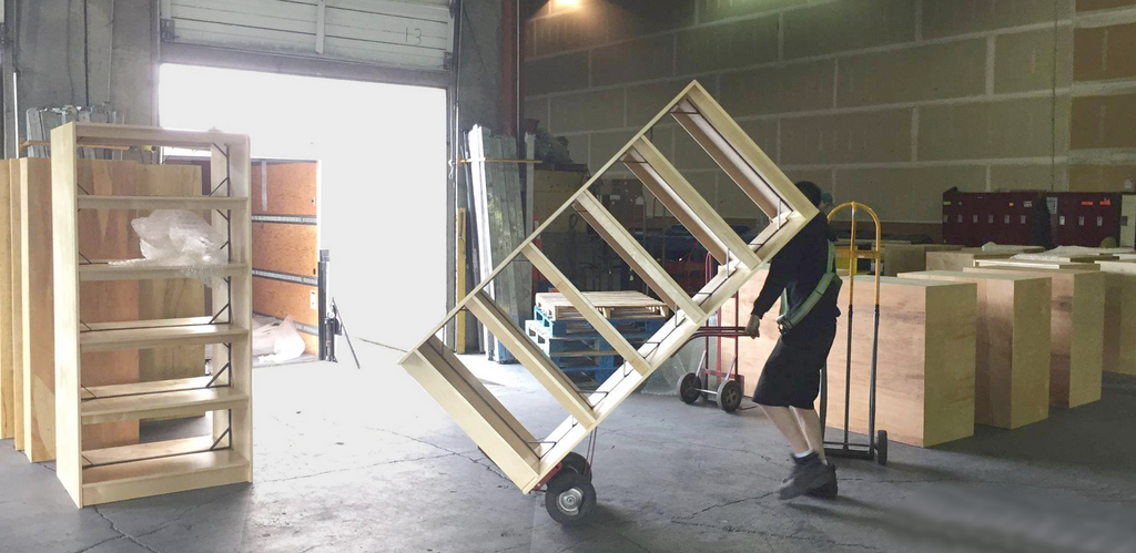 Bandstra Transportation moves shelves from its loading dock onto a truck, for shipping to a library.