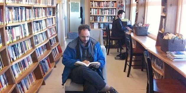 A reader and a computer user in the library at Bella Bella.