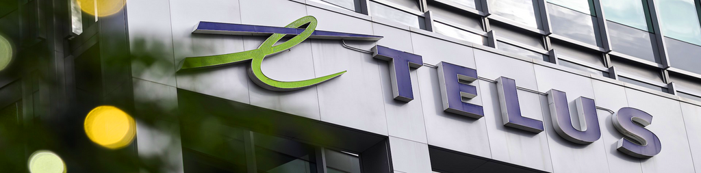Close-up of the Telus logo on an office building.